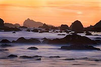 Sunset and misty waves breaking on beach in Crescent City, California. USA