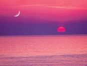 Moon and setting sun over Straits of Juan De Fuca, from San Juan Island, Washington State, USA.