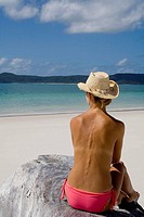 Back of a topless woman in a cowboy hat, Witehaven Beach, Australia