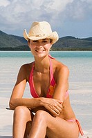 Portrait of woman in bikini and cowboy hat. Whitehaven Beach, Australia.