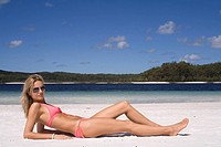 Beautiful woman lying on beach. Fraser Island, Australia
