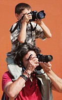 Father and son taking pictures at airshow. Barcelona. Spain