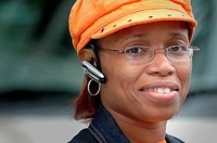 Black woman with cell phone and hat