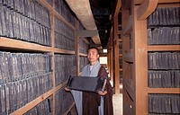 Buddhist monk presentinf one of the 80000 wooden blocks on which are carved the complete Buddhist scriptures of ´Tripitaka´, Haein-sa monastery. South...