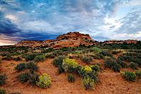 Storm clouds gather over an unnamed sandstone butte in the Sand Flats area east of Moab, Utah, USA