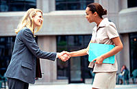Business women meet with handshake.