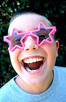 Laughing boy with sunglasses.