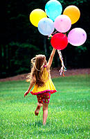 Girl running with balloons.