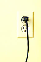 Outlet on wall with plug.