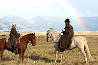 Cowboy and cowgirl with rainbow. Montana, USA