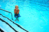 Boy shivering in swimming pool