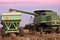 Lee Farm Fall 2007 Hardin County Fall corn harvest in Hardin County Iowa with John Deere combine unloading corn into wagon for transport to grain bins...