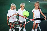 Kids posing with an oversized tennis racket and ball