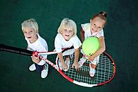 Kids playing with an oversized tennis racket and ball