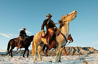 Cowboys out for a ride in winter, Shell, Wyoming, USA