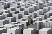 Couple in the Holocaust memorial. Berlin. Germany