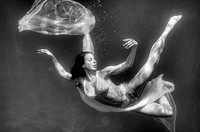 Girl swimming underwater, diving angel.
