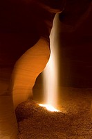 Shaft of sunlight in slot canyon, Canyon X, near Page, Arizona, USA