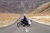 A Tourist is driving Enfield in Himalayas.