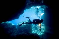 scuba diver diving in cave