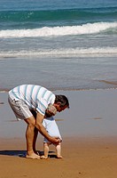 Middle-aged man and baby on the beach