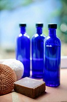 three blue glass bottles and soap in the bathroom