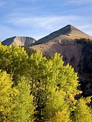Mount Tukuhnikivatz rises above golden aspens on a fall afternoon in the La Sal mountains outside Moab, Utah