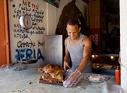Man cutting roast pork, Sosua, Dominican Republic, 2008