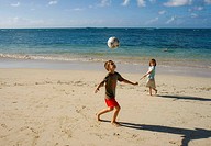 Boy and girl at Las Terrenas beach with soccer ball, Dominican Republic
