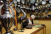 Working in silver covered crafts handwork at a shop in Fez, Morocco