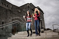 Two female college students walking down steps, University of British Columbia, Vancouver, BC, Canada