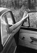 Seventies, black and white photo, humour, people, naked legs of a girl looking out of the passenger door of a car, aged 18 to 25 years, Monika