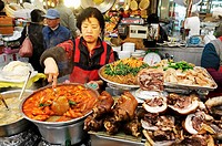 korean food, woman cooking in a small restaurant, food stall in a market in Seoul, South Korea, Asia