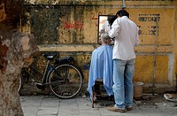 Street barber in the old town of Hanoi.