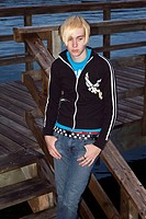 Young emo-styled man on a dock