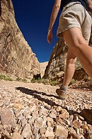 Woman hiking into the Grand Wash slot canyon in Capital Reef National Park, Utah