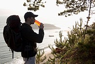 Hiker drinking water along Pacific Ocean Trail. Santa Cruz, California