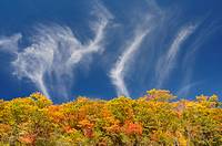 Three clouds perfom a dance on Blue Ridge Parkway in early October at peak fall color