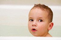 A portrait of a boy in the bathtub