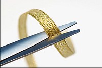 Close-up of a gold ribbon and scissor