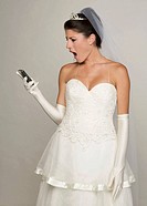 Bride in her 20s looks amazed/disgusted at cell phone