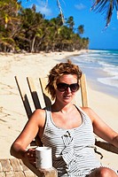 Tourist sitting in chair on beach, Playa del Pablo, Little Corn Island, Corn Islands, Nicaragua
