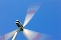Spinning Wind turbine generator against blue sky
