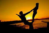Performers practice their dance routines at the beach during sunset in Byron Bay. New South Wales, Australia