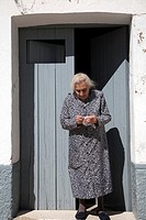 Old lady at her house´s door, town of Castaño del Robledo, province of Huelva, Andalusia, Spain