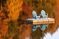 two adirondack chairs on dock in autumn