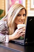 Woman smiling using computer