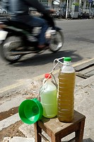 Small volumes of petrol for the many small motorbikes are sold almost everywhere, Nha Trang, Vietnam