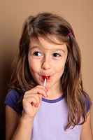 Young girl with red lollipop candy