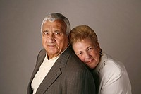 Married senior couple posing for studio portrait